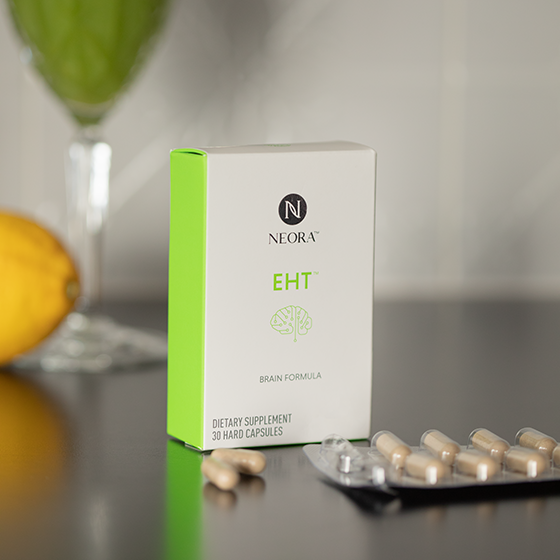 Neora's EHT box and sleeve of capsules laying on a kitchen counter.